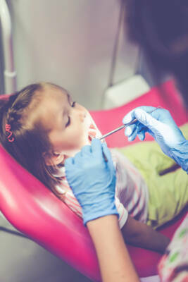pediatric dentist. Little girl at the reception at the dentist.